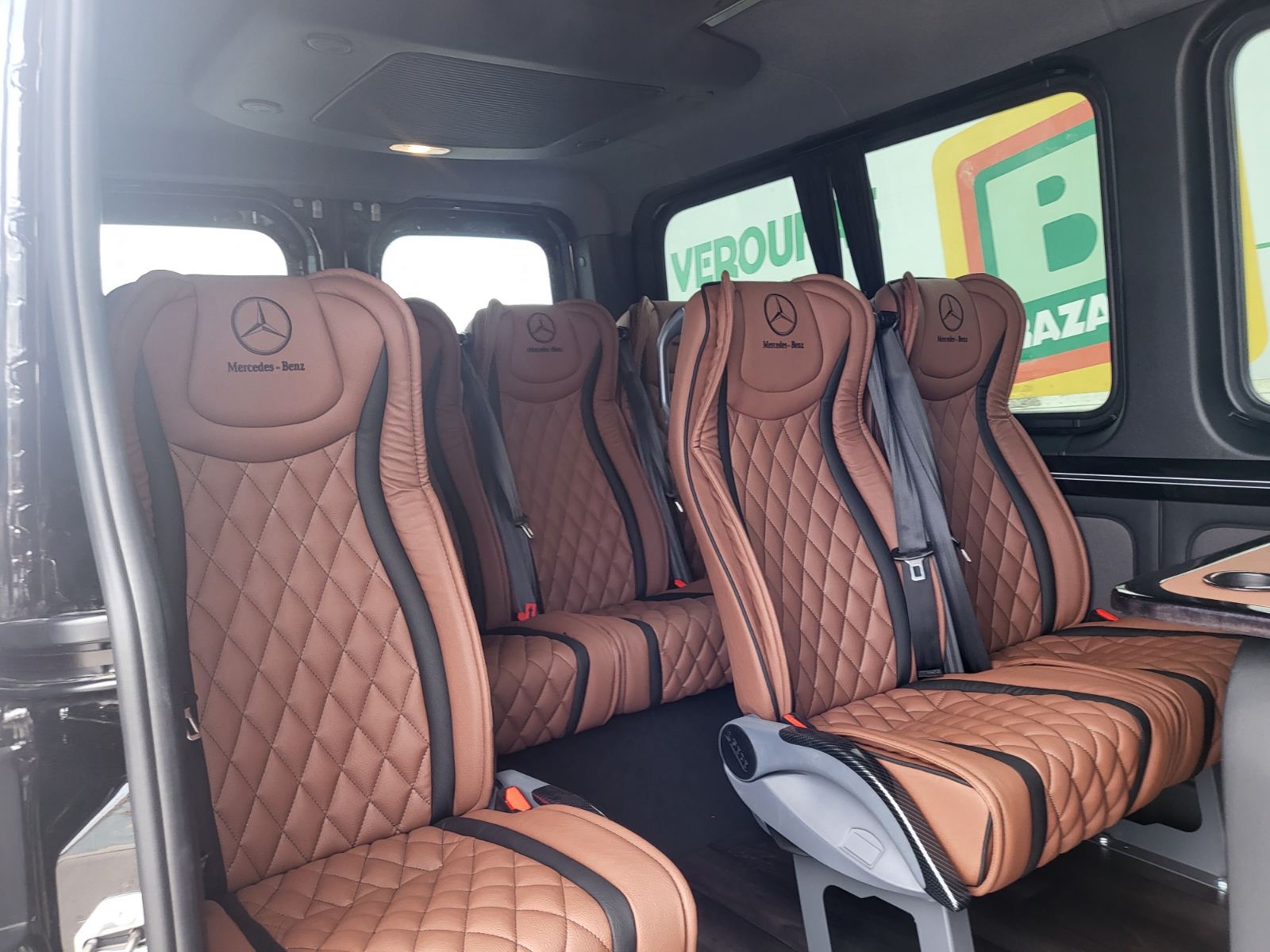Quilted brown leather interior of the Mercedes Sprinter with ambient lighting